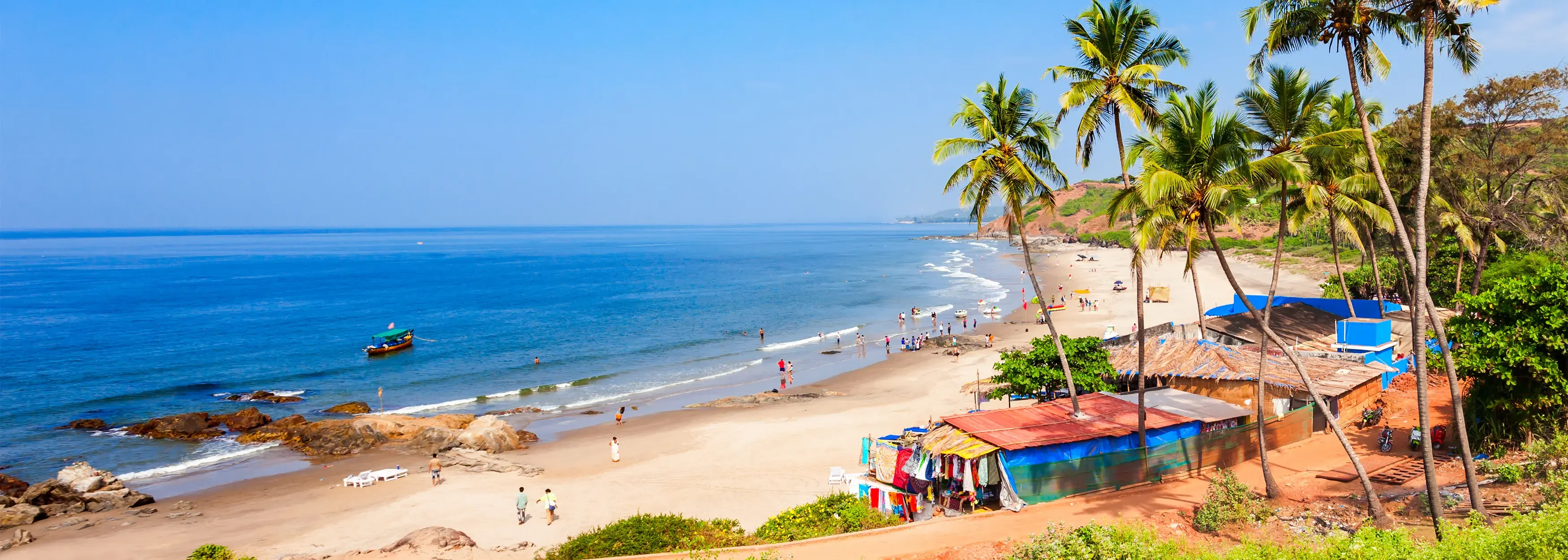 Golden sand stretch at Calangute Beach, Goa, India. Lots of people relaxing. Good for Goa tour plan.