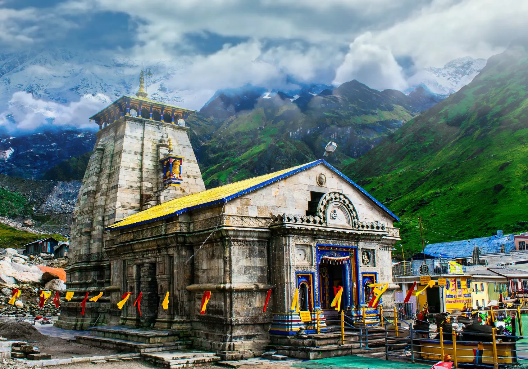 Kedarnath Temple on Char Dham Yatra. Snowy mountains in background. Spiritual place for pilgrims. A must-see.