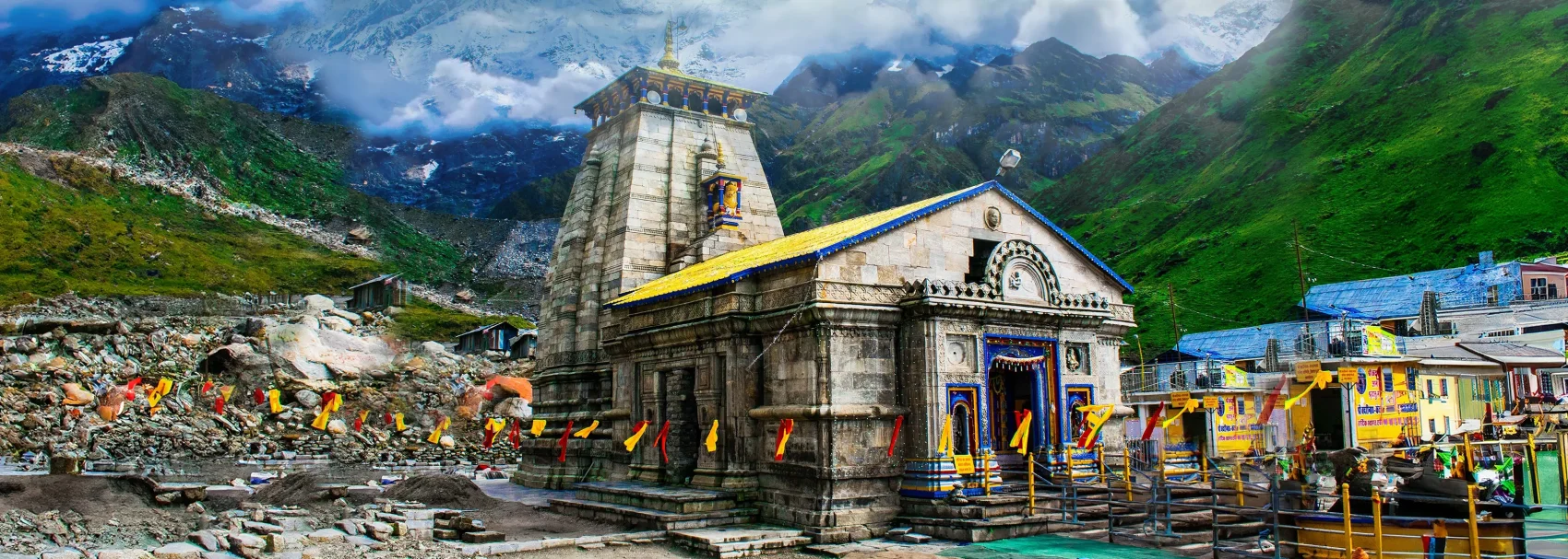 Char Dham Yatra stop at Kedarnath Temple. Stone building, lights on. Peaceful view in the Himalayas. Worth the long trip.