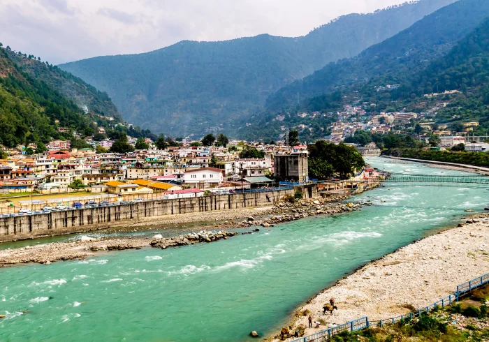 Uttarkashi town, Char Dham Yatra starting point. Scenic view of Bhagirathi River through mountains.