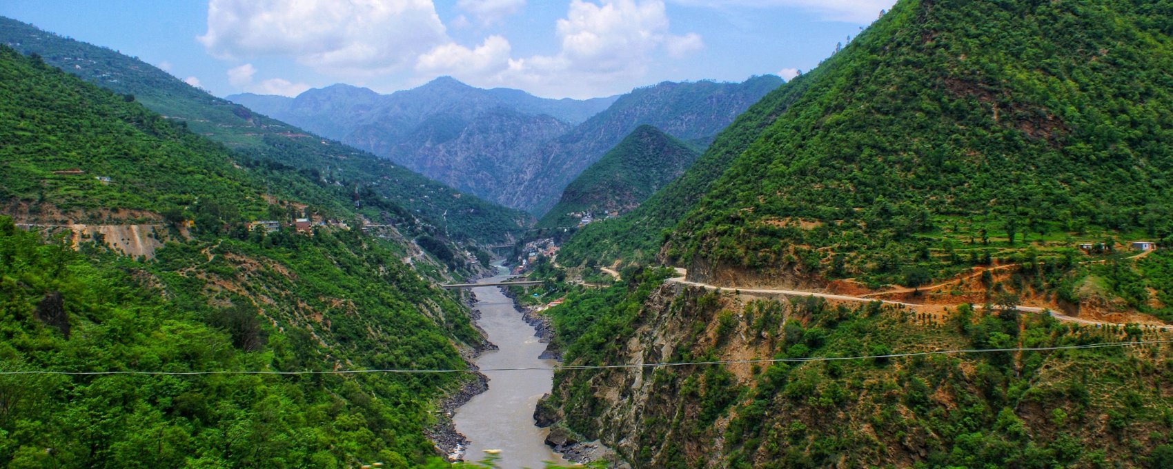 Beautiful landscape image of a river and mountains in Uttarakhand, perfect for those exploring the Char Dham Yatra.