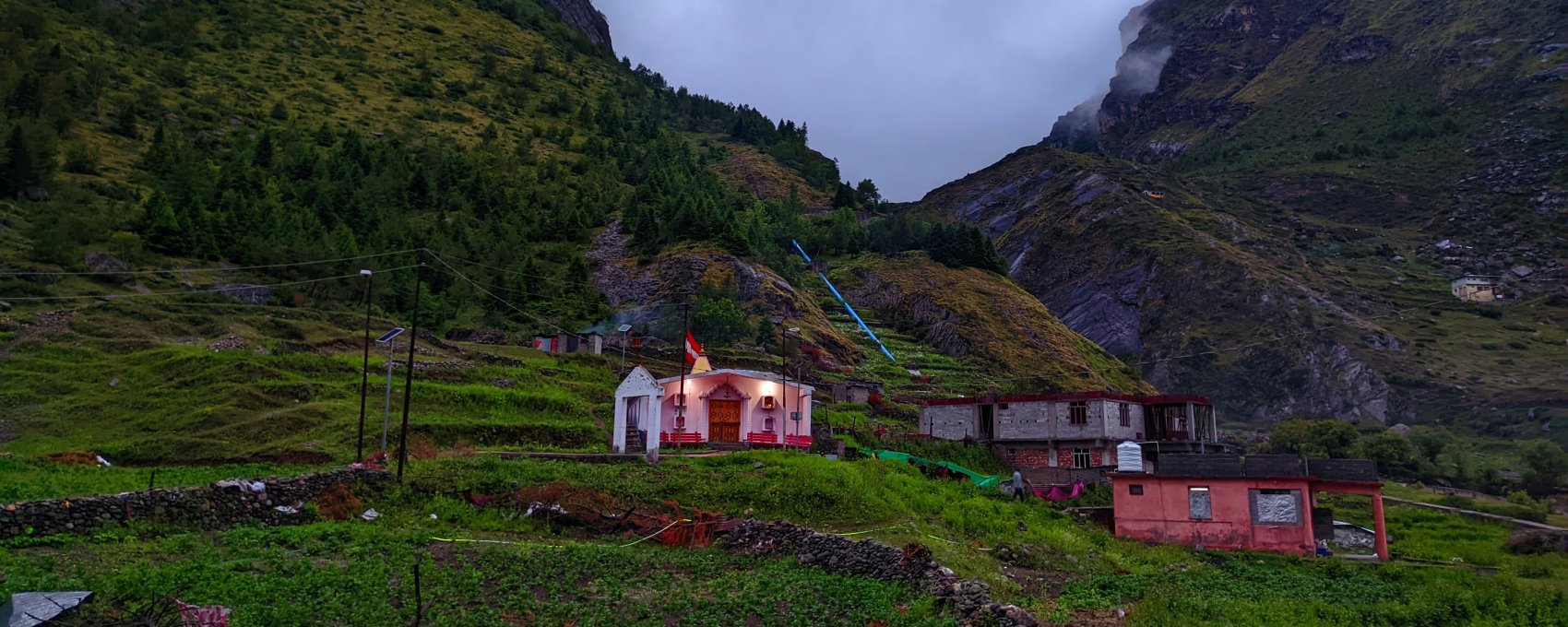 View of Badrinath temple, important for Char Dham Yatra, in Uttarakhand mountains.