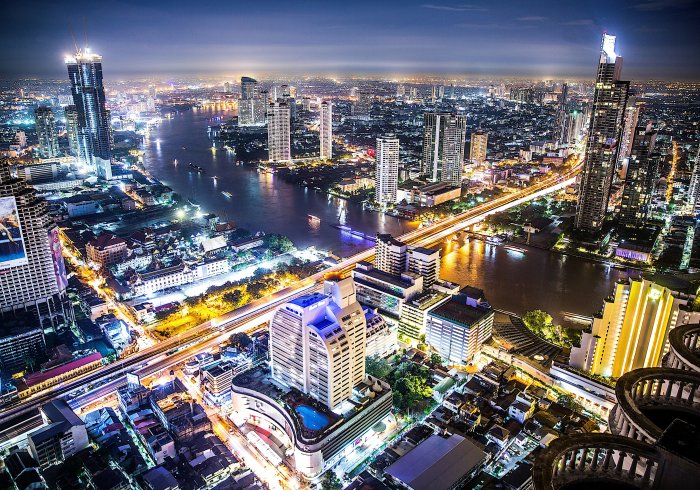 Bangkok tour night skyline, river view with skyscrapers. Experience the city's magic!