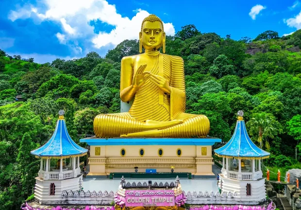 Golden Buddha statue at Dambulla Cave Temple in Sri Lanka, a must-see for any Sri Lanka tour.